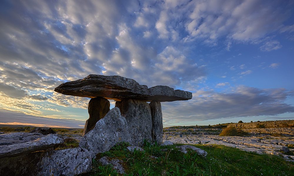 Sunset over Poulnabrone dolmen an ancient portal tomb in the Burren, County Clare, in the west of Ireland. High quality photo